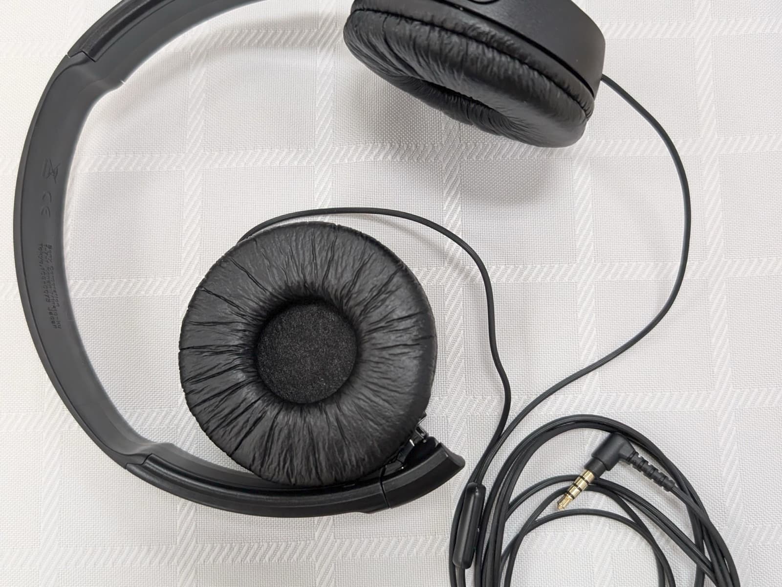 The monitoring headphones used for narration work, laid flat with the cable coiled beside them
